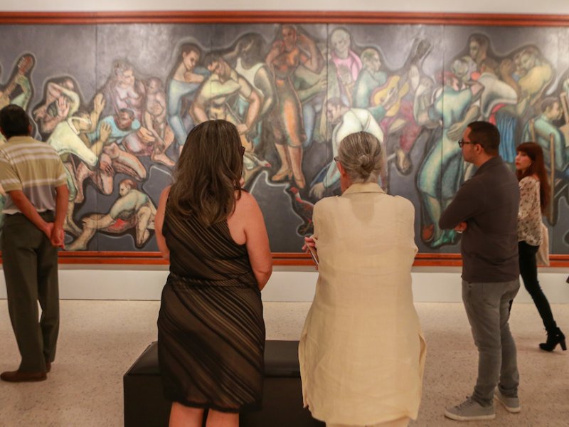 People admire a great painting in a museum