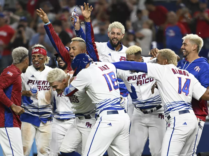 Puerto Rican baseball players with blonde hair celebrating victory