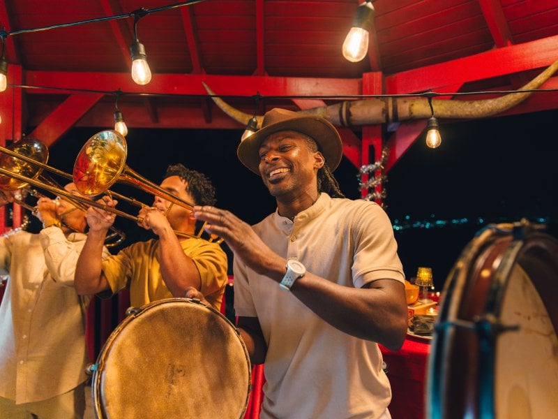 A group of people playing tambourines and the trumpet.