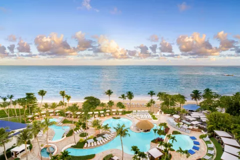 Stylish pool scene at Fairmont El San Juan, a historic favorite among the best Puerto Rico resorts.
