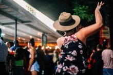Woman dancing at a lively outdoor night market in Puerto Rico