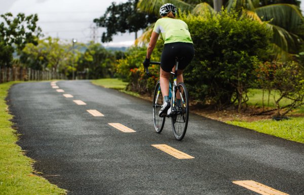Biker biking along a scenic pathway in Paseo Lineal, Bayamón's Central Park.