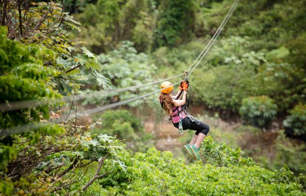 A woman flies down a zipline at Toro Verde Adventure Park.