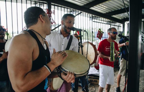 Three musicians perform Puerto Rican music.