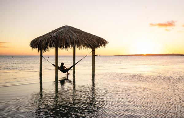 A woman relaxes in an overwater hammock at Copamarina Resort in Guánica.