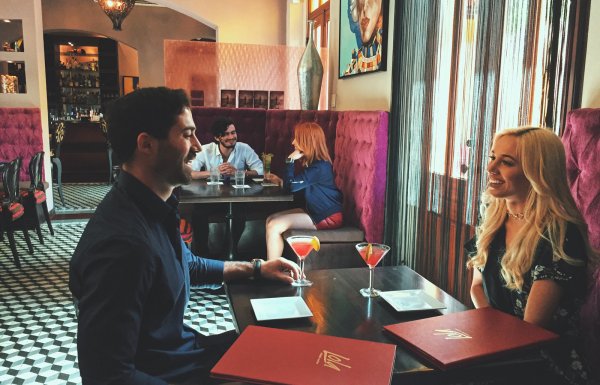 A couple enjoys their cocktails at a restaurant in Ponce.