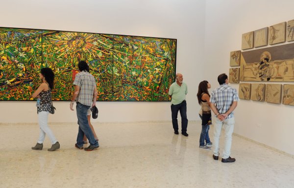 People view an art exhibit at the Museo de Arte de Bayamon.