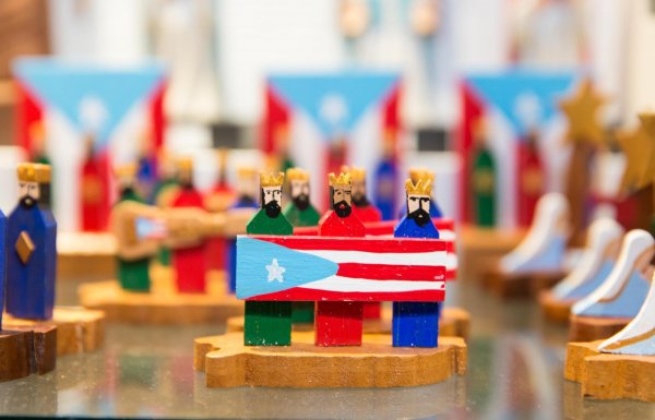 Three Kings of Puerto Rico holding the Puerto Rican flag.