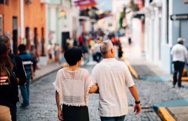 A couple enjoys a stroll through the cobblestone streets of Old San Juan.