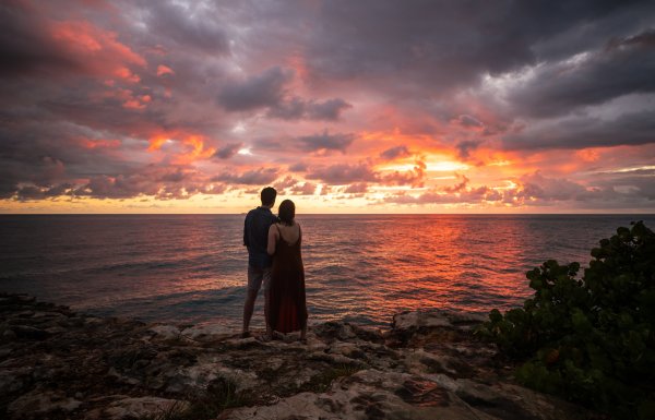 A couple watches the sunset at Cabo Rojo