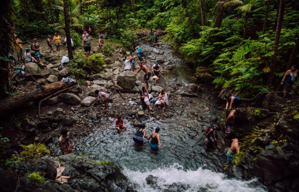 People enjoy the waterfall at Juan Diego Falls in El Yunque