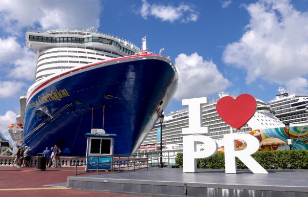 The "I Love PR" sign in front of a large cruise ship at the Old San Juan Port.