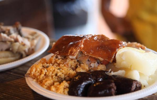 View of a traditional Puerto Rican holiday dish filled with rice and pigeon peas and lechón asado.