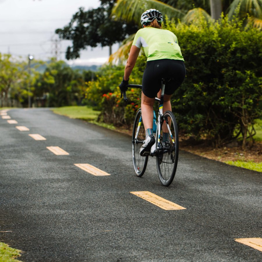 Biker biking along a scenic pathway in Paseo Lineal, Bayamón's Central Park. 