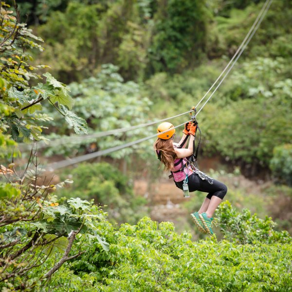 A woman flies down a zipline at Toro Verde Adventure Park.