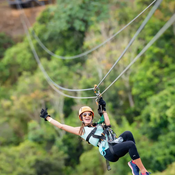 Woman zipping down the Toro Verde Zipline