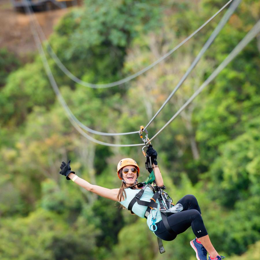 Woman zipping down the Toro Verde Zipline