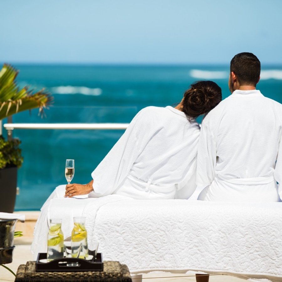 A couple enjoys a luxurious massage outside at the Condado Vanderbilt Hotel.