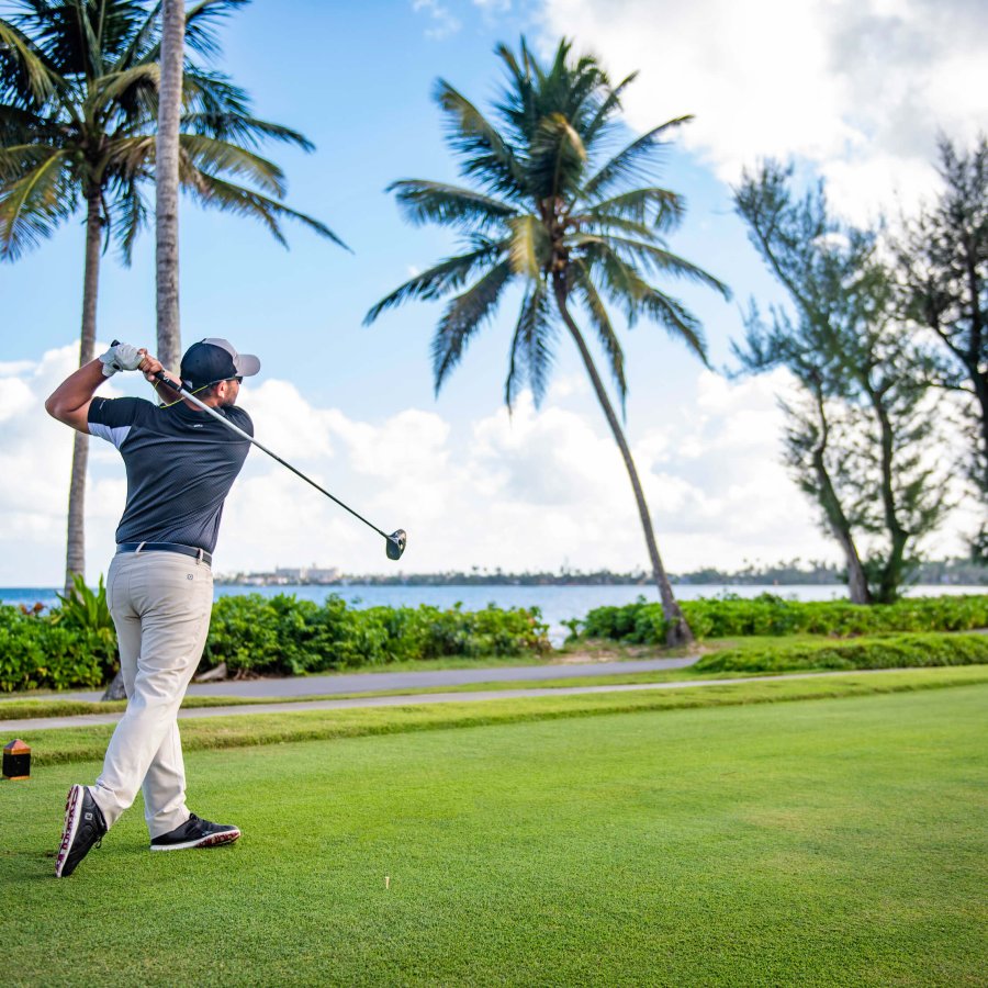 A golfer plays one of the three scenic golf courses at Dorado Beach, a Ritz-Carlton Reserve. 