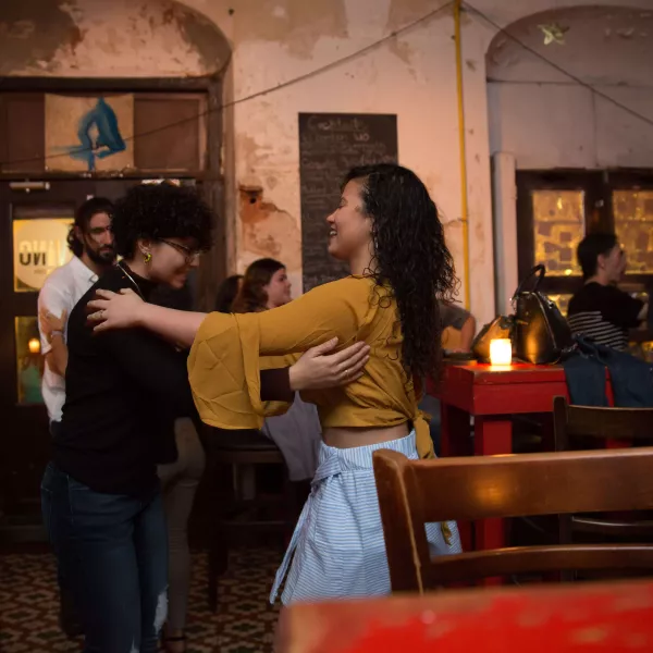 Two people practice dancing together.