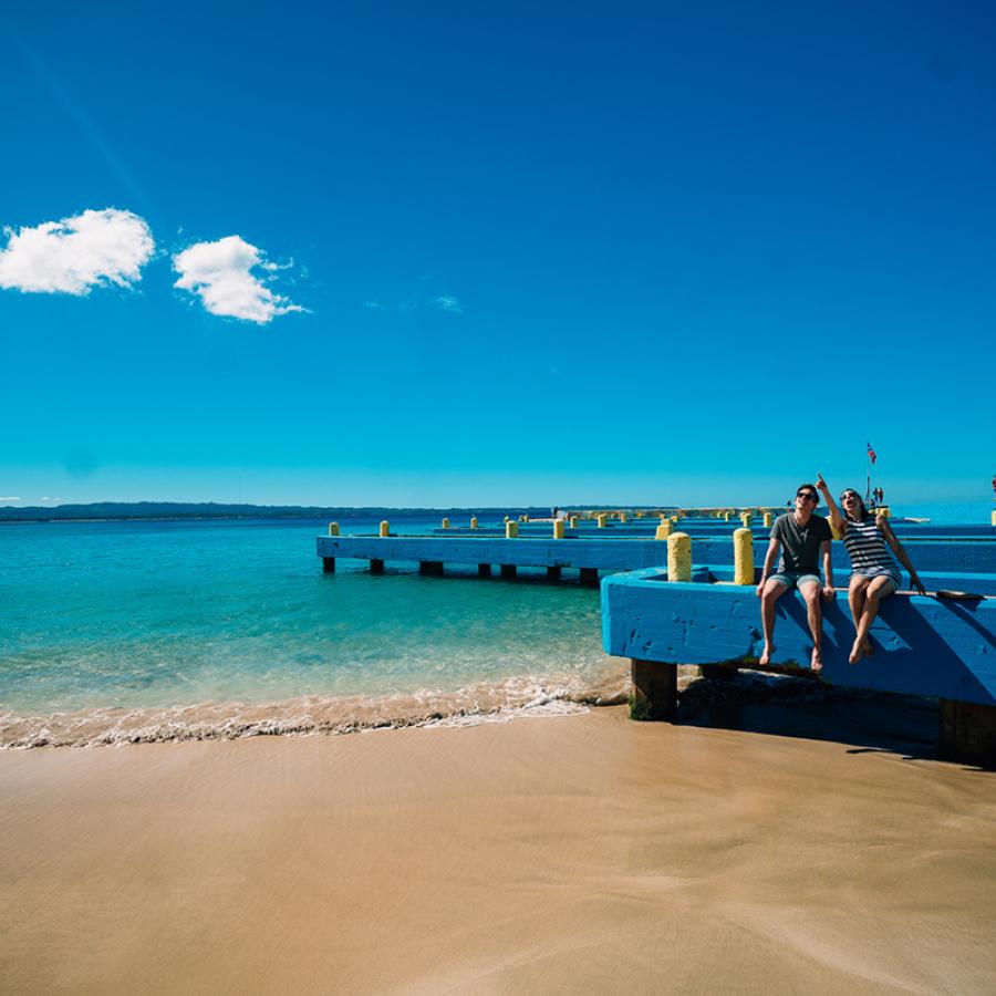 Two people enjoying Crashboat Beach in Aguadilla.