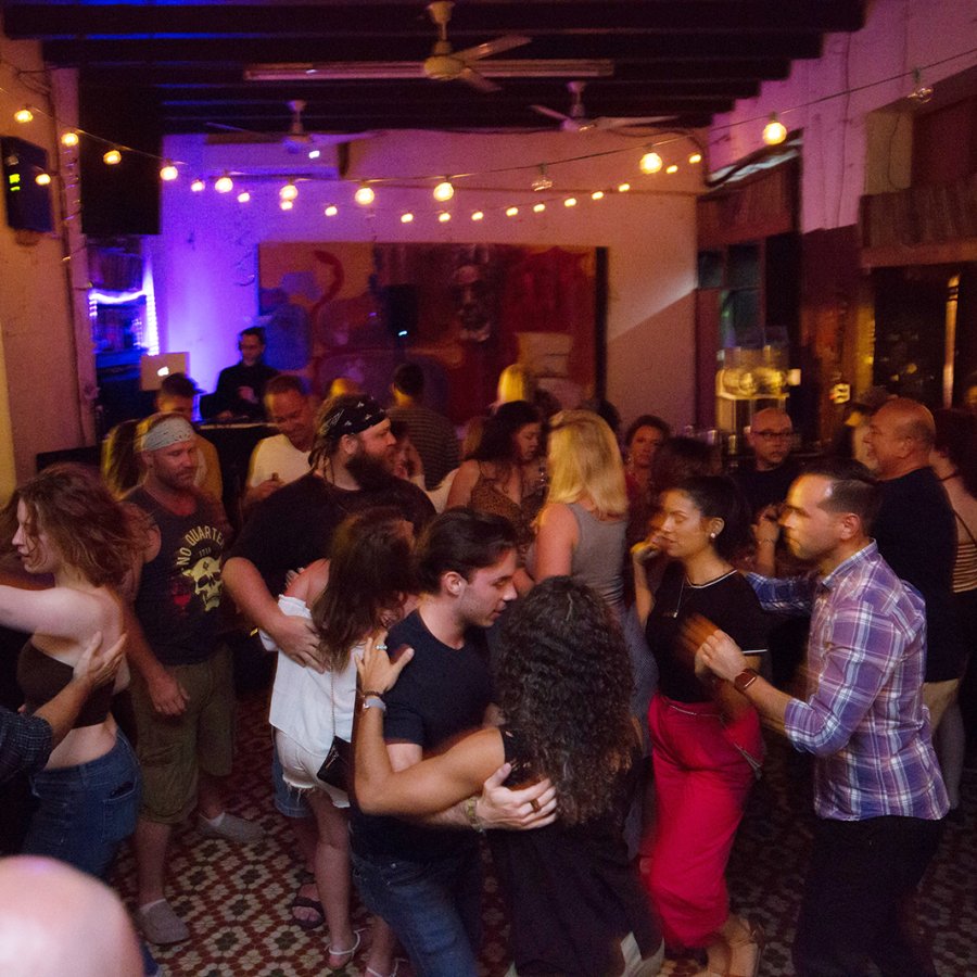 People dance and smile around La Factoria