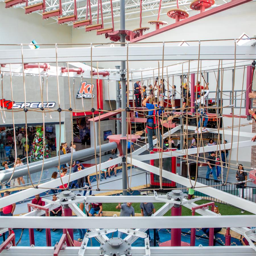 Kids navigate the indoor aerial ropes course at Route 66 Mall.