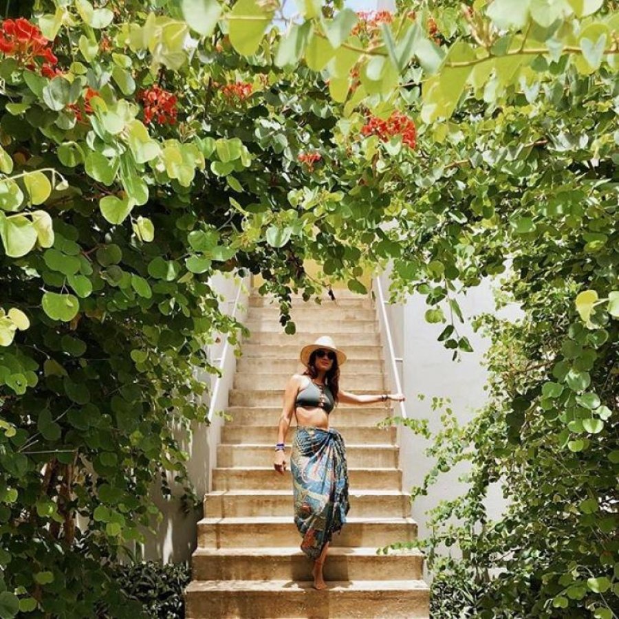 A woman goes down stairs at the Hix Island House in Vieques.