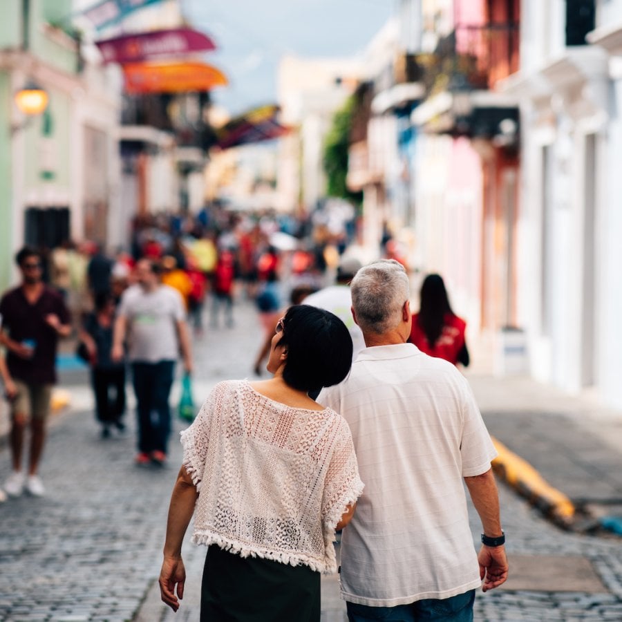 A couple strolls down San Juan's historic cobblestone streets.