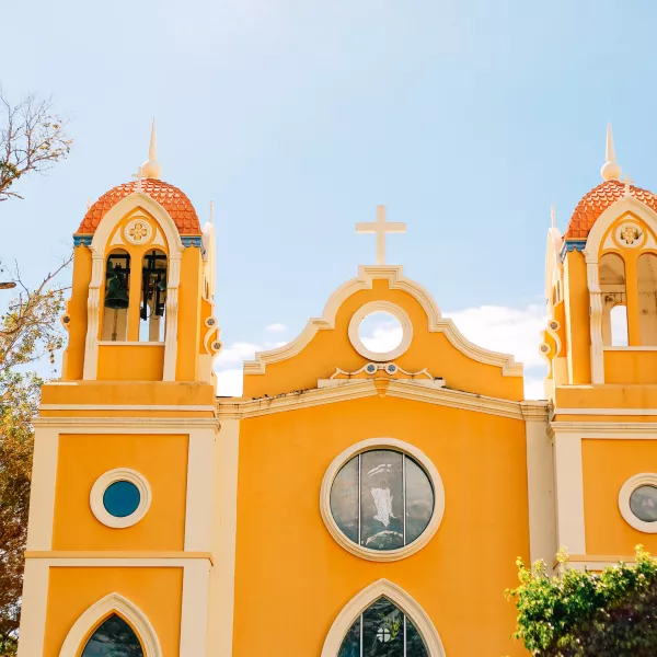 The bright yellow Spanish Mission-style church overlooking the town plaza in Anasco