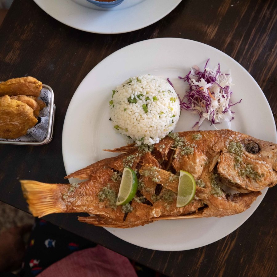 A savory dish with deep fried fish and white rice.