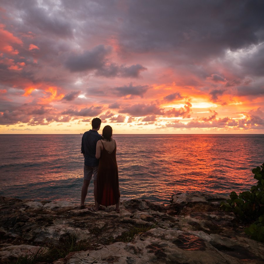 A couple watches the sunset at Cabo Rojo