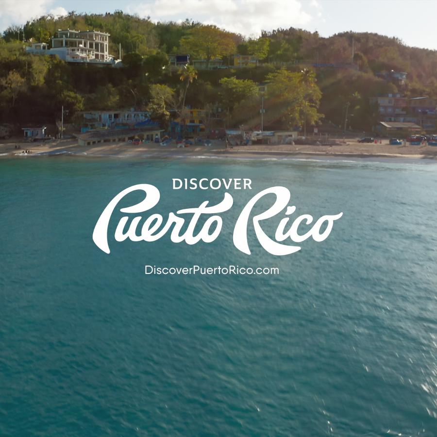 Discover Puerto Rico logo over a photo of the ocean and a beach