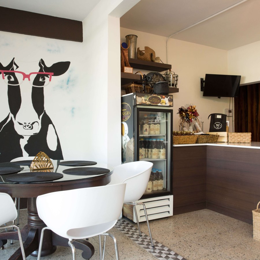 Interior view of a room with a large cow painting