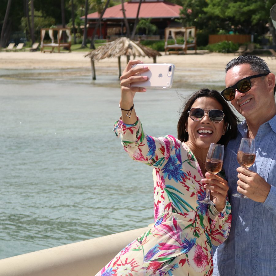 Couple taking a selfie in front of the beach in Copamarina Resort in Guanica