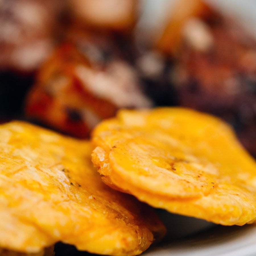 Tostones crujientes, un aperitivo tradicional de la comida puertorriqueña preparado con plátanos verdes fritos.