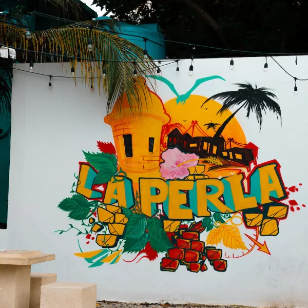 Colorful street art mural in La Perla, showcasing the neighborhood’s vibrant culture.
