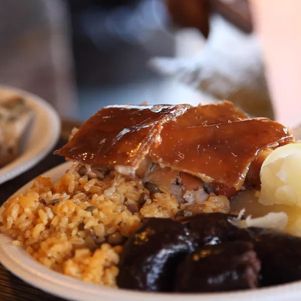 Plate of lechón, arroz con gandules, and morcilla at a lechonera in Puerto Rico