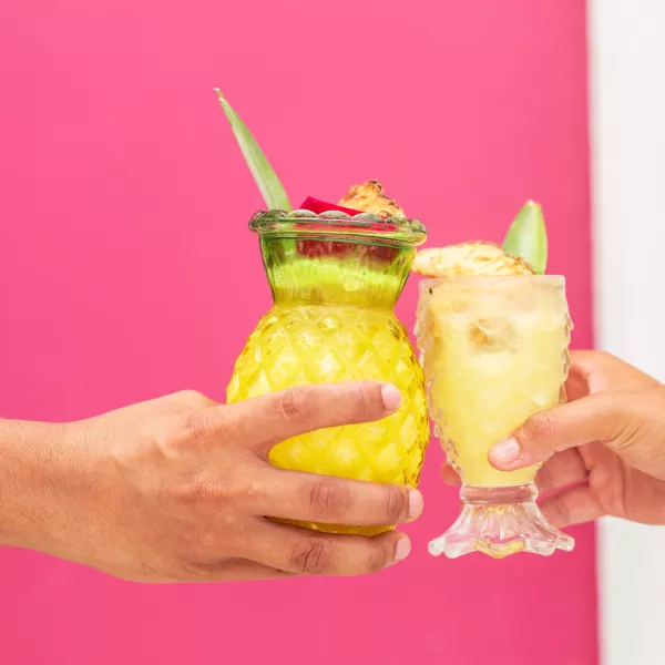Cheers with piña colada.