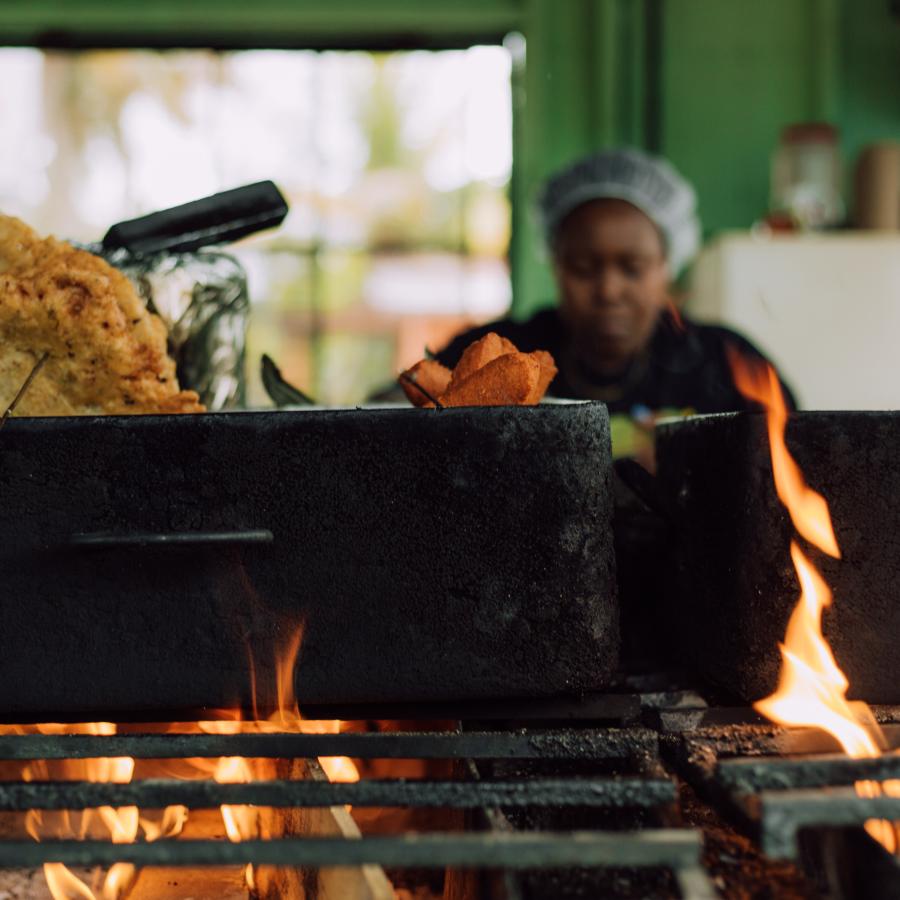 A woman serves Puerto Rican fritters