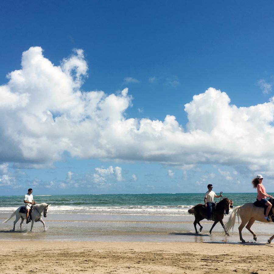 Horseback riding in the beach.