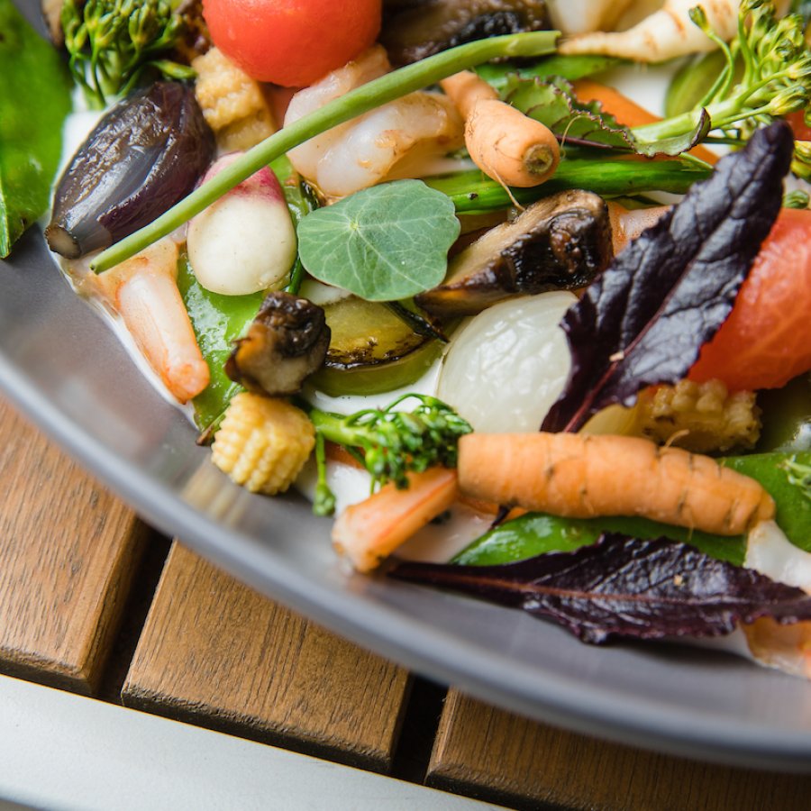 A plate with a spring salad from a vegan restaurant. 