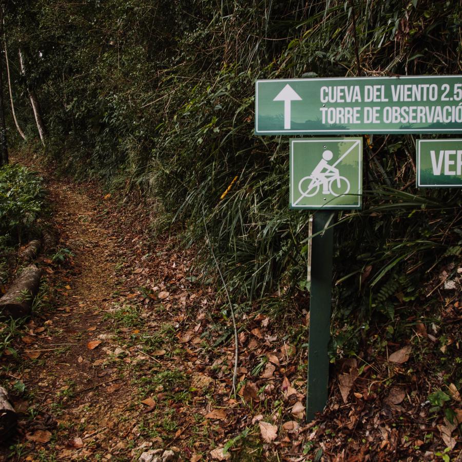 A sign points to the entrance of Cueva del Viento in Isabela