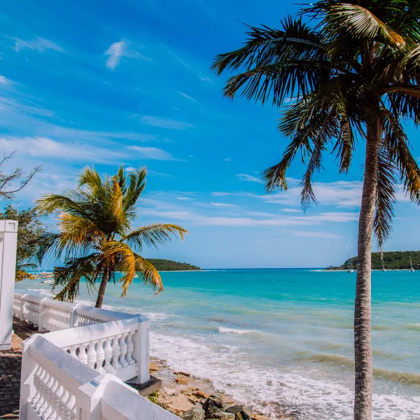 Visitors stroll along a scenic oceanfront walkway in Vieques, Puerto Rico.