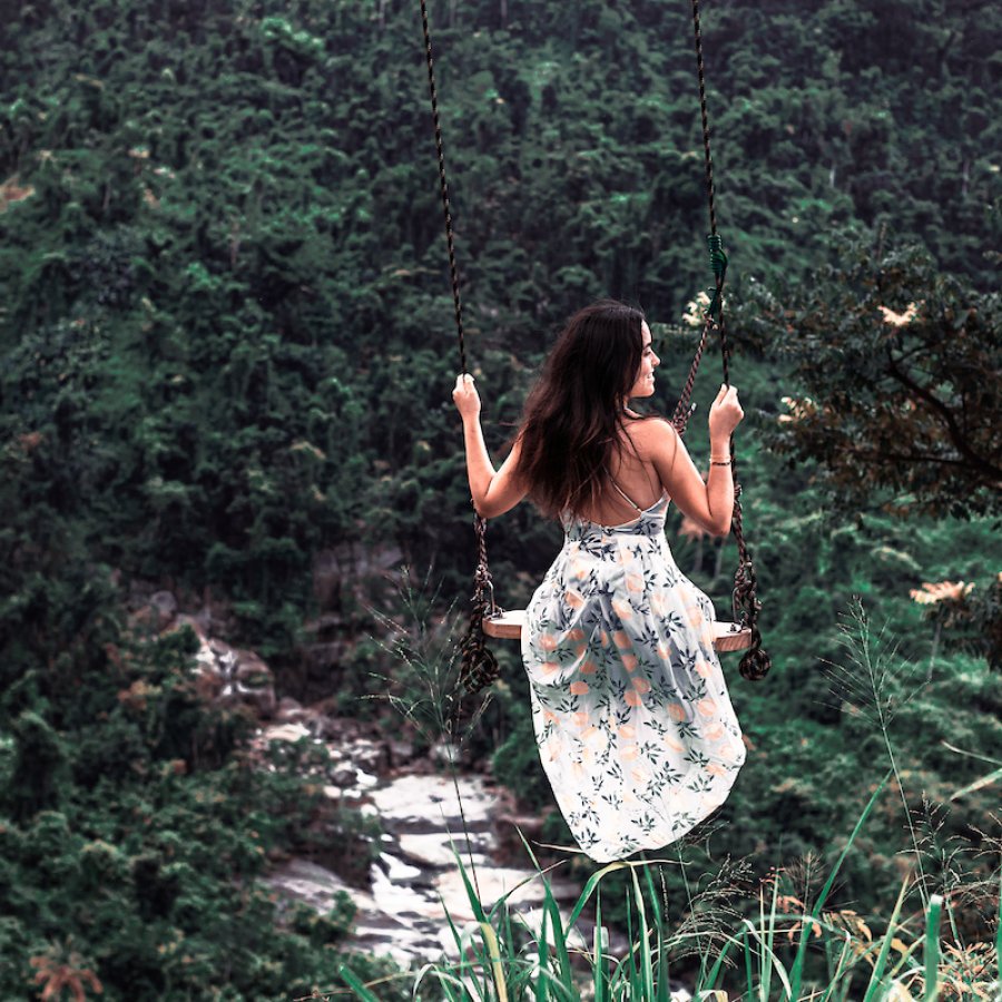 A woman swings from Columpio de los Suspiros in Naguabo