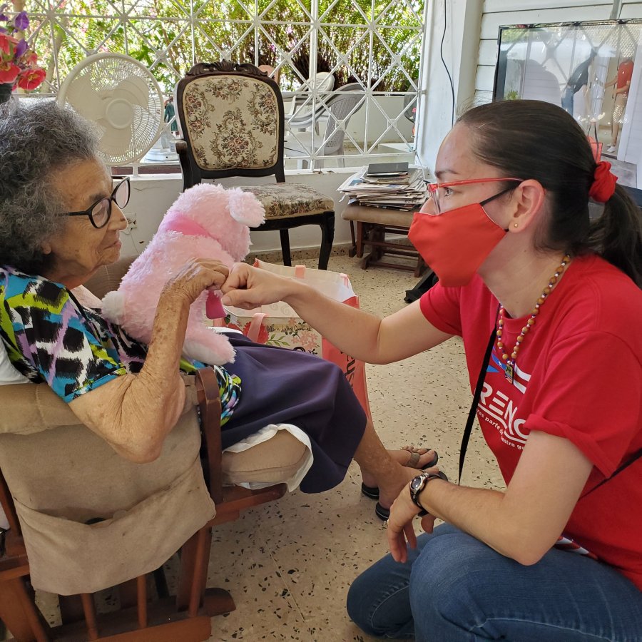 A volunteer nurse looks after an elderly woman in Puerto Rico. 