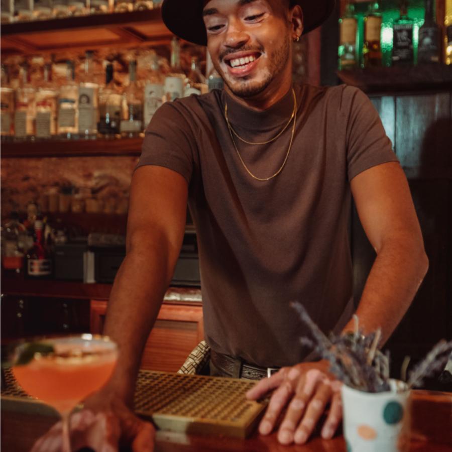 A bartender serves a drink at a bar in Puerto Rico
