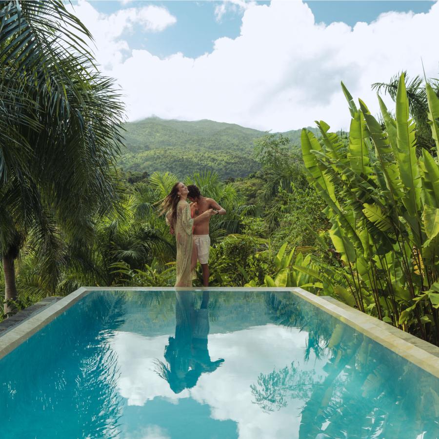 A couple embraces at the edge of an infinity pool in Rio Grande, Puerto Rico