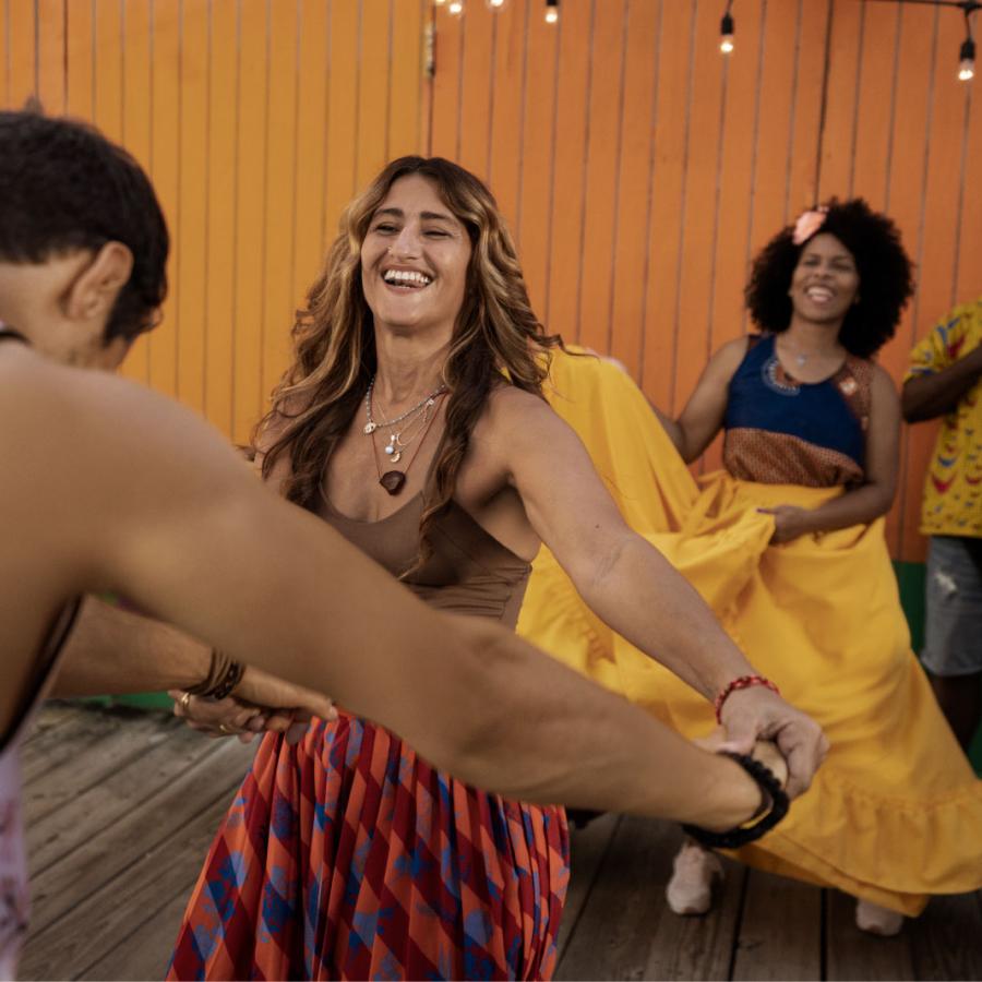 A group of people dance in vibrantly colored costumes in Puerto Rico