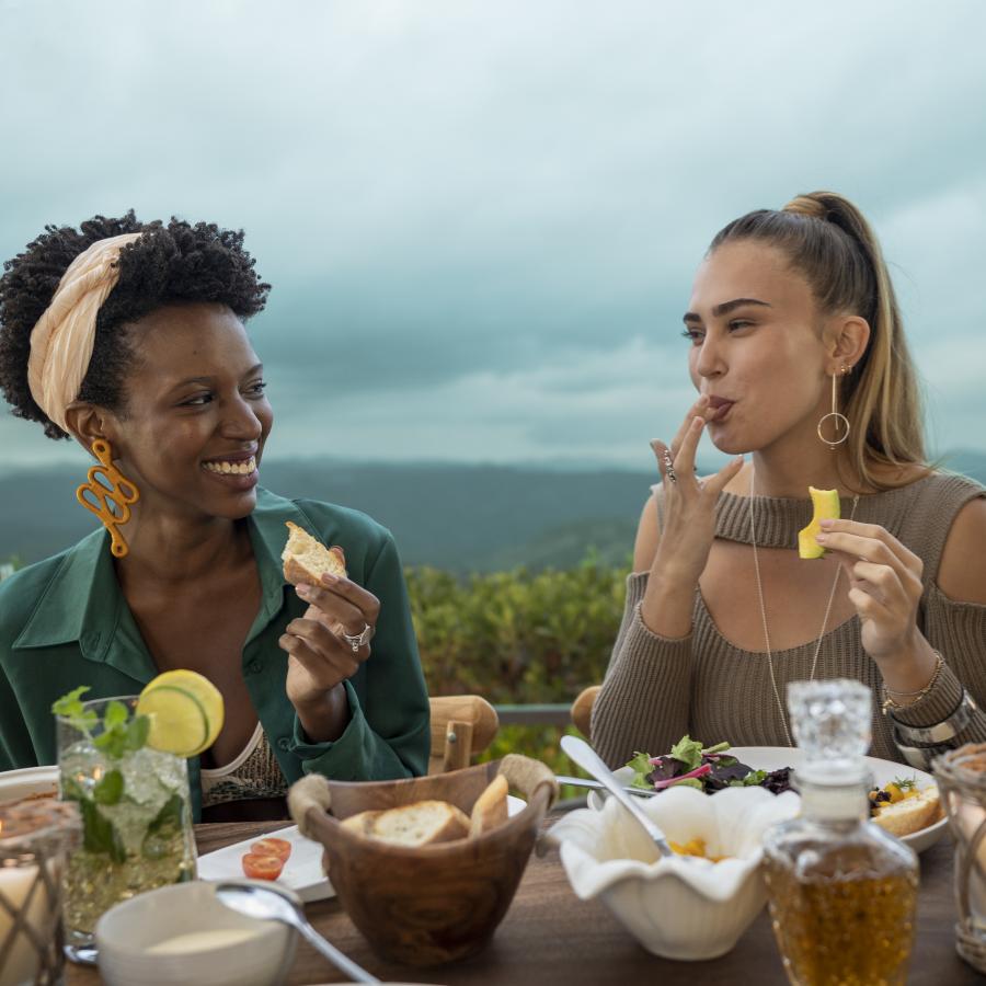 Two women share a meal at an outdoor restaurant in Puerto Rico